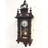 A Victorian mahogany Vienna wallclock, having pierced crest with turned finials and prancing horse