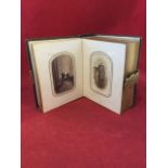 A Victorian leather bound photograph album dated 1863 having gilt tooling and brass mount, the