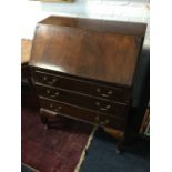 An Edwardian mahogany bureau, the fallfront enclosing an interior with stationary rack,