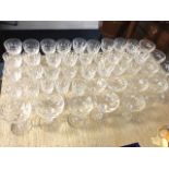 A suite of glasses - sherry, champagne, wine, etc., the bowls all cut with oval facets, raised on