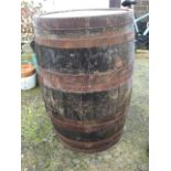 A 3ft oak barrel, the staves bound by four metal strap bands. (35in)