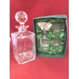 A square cut glass decanter & stopper engraved with a golfer; and a cased small glass set with a