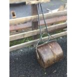 A garden roller with twin drum on iron frame having T-bar wood handle.