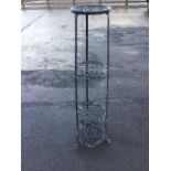A 4ft wrought iron garden plant stand, having four circular pierced tiers in a tower, raised on