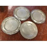 A set of three London hallmarked eighteenth century pewter plates; and another similar with London