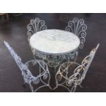 A wrought iron wirework garden table and chair set, the circular table with scrolled frieze on