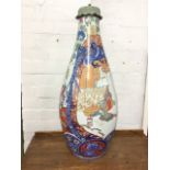 A large nineteenth century pear shaped Japanese Imari vase, decorated with figures in the garden