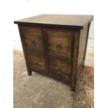 A dwarf chest of four small drawers mounted with ring handles. (19.75in x 15.75in x 20.5in)