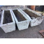 A set of three rectangular composition stone troughs, the tapering sides cast with faux