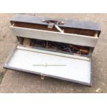 A rectangular wood toolbox with internal drawer containing miscellaneous tools and materials -