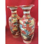 A pair of Japanese satsuma vases with fluted waisted necks and applied handles, decorated in the