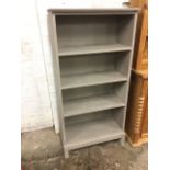 A painted open bookase with four open shelves on block feet. (26.5in x 12in x 52.75in)