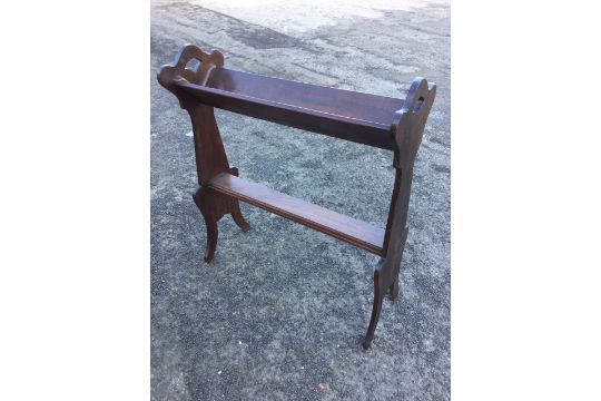 A walnut book trough with angled shelf on shaped ends with waisted legs, joined by moulded - Image 1 of 6