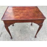 An eighteenth century mahogany silver table, the rectangular tray top with shaped aprons supported