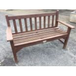 A 4ft garden bench with slatted back and seat, having platform arms raised on rectangular legs. (