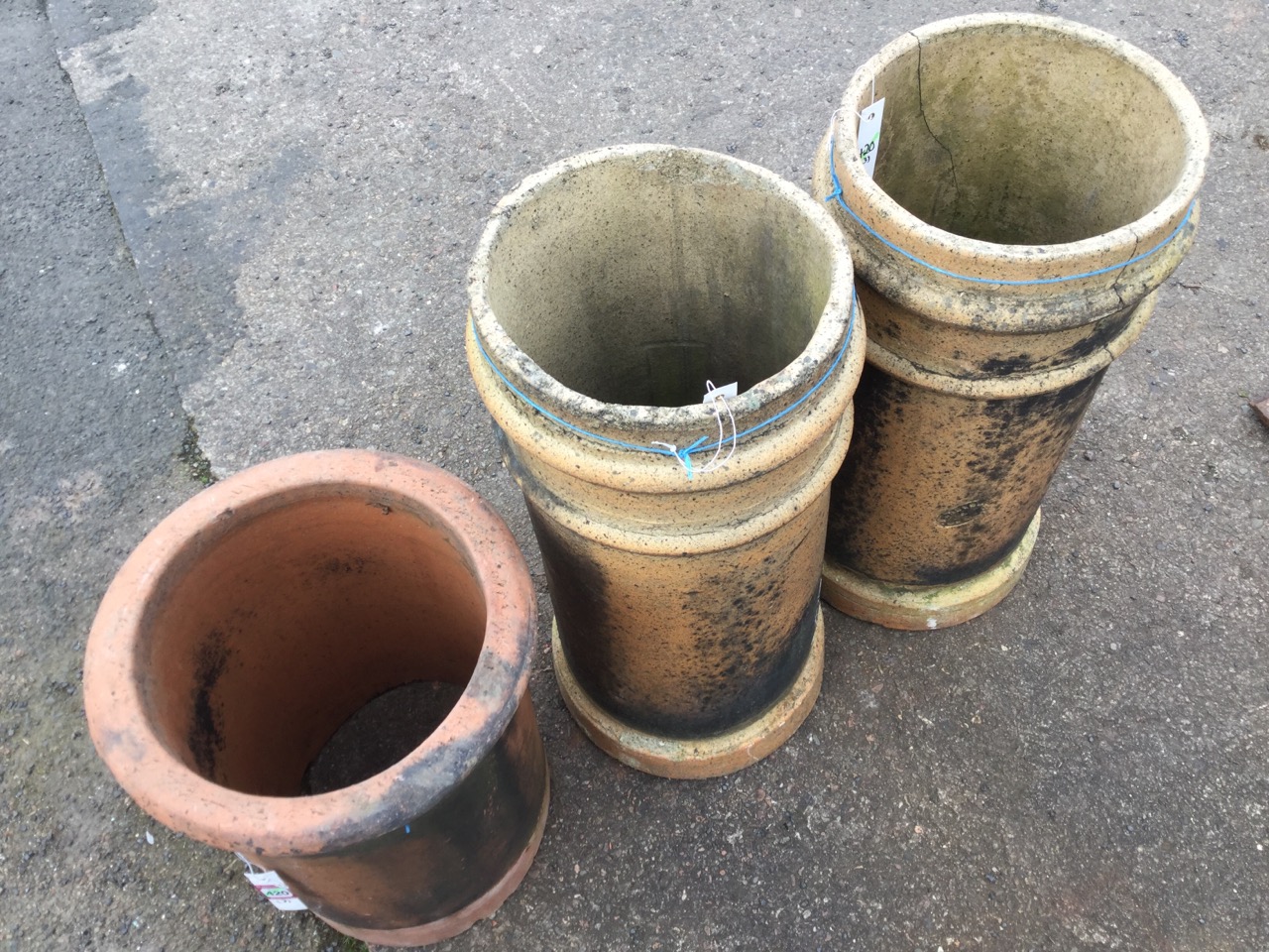 A pair of 2ft stoneware tubular chimney pots; and an 18in terracotta chimneypot with moulded rim. ( - Image 5 of 6