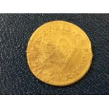 A George III 1800 gold third guinea, the coin in used condition. (.75in)