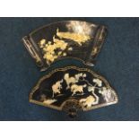 Two Japanese fan and scroll shaped lacquered panels with handpainted gilt decoration having