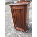An Edwardian mahogany pot cupboard with reeded panelled door in moulded rails & stiles, raised on