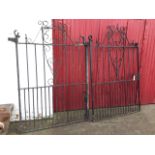 A pair of 6ft wrought iron driveway gates, the crest and central panels with scrolled decoration