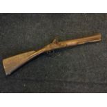 A nineteenth century flintlock blunderbuss with hardwood stock and flared barrel, the lock with