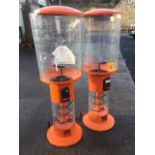 A pair of tubular fairground type toy dispensers on trolley stands. (68in) (2)