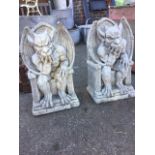 A pair of composition stone gryphons, the horned winged beasts seated on arched thrones. (19in) (2)
