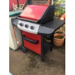 A outdoor three-burner gas BBQ stand by Berkley, the garden trolley on wheels having hinged hood