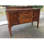 An Edwardian mahogany sideboard, the rectangular top with reeded edge beneath a greek key blind