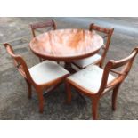 A reproduction regency style yew dining room suite, the circular crossbanded table on turned