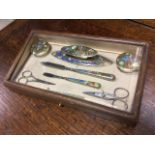 A glazed leather cased ladies vanity set, finely enamelled with floral decoration, birds, ribbons,