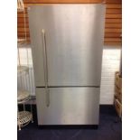 A large stainless steel Amana American style fridge freezer, working when uplifted from house. (36in