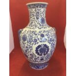 A large Chinese blue & white baluster vase, overall decorated with floral scrolling and mounted with