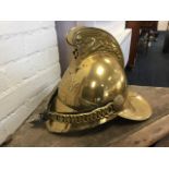 A replica brass firemans helmet with dragon embossed crest and New South Wales badging, having