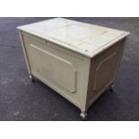 A painted oak blanket box with moulded top above a raised panel chest, on square shaped legs with