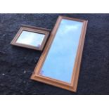 A modern rectangular pine cushion framed mirror; and a satin walnut framed mirror with bevelled