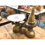 A set of Victorian cast iron scales, the circular porcelain weighing platform decorated with