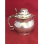 A nineteenth century bulbous silver plated tankard with scrolled handle and thumbpiece, the domed