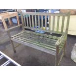 A 4ft garden bench with slatted back and seat having shaped platform arms, raised on rectangular