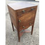 A nineteenth century mahogany nightstand with later top, the cupboard and drawer inlaid with ebony