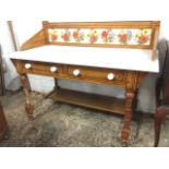 A late Victorian aesthetic marble topped washstand with original painted decoration, having floral