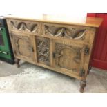 A late Victorian carved oak sideboard, the rectangular top above a pair of leaf shaped deep-carved