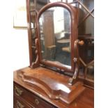 A Victorian mahogany dressing table mirror, the arched cushion framed plate on scrolled supports