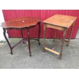 An oval mahogany scalloped top occasional table on tapering legs united by conforming platform;