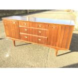 A 1960s rectangular walnut sideboard, the central section with two short and two long drawers