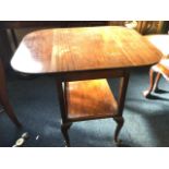 A mahogany supper table, the rounded top with drop leaves on square column supports joined by tray