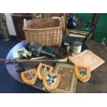 A basket of miscellaneous collectors items including oak shields, horn cups, leather embossed