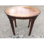 An Adams style Edwardian oval mahogany occasional table, the top with carved edge above a fluted