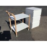 A modern white three drawer chest; and a beech trolley with two shelves, the column cornerposts on