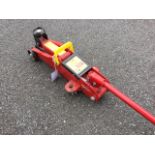 An unused trolley jack, the hydraulic machine with detachable crank bar on wheels - to lift 2000kg.